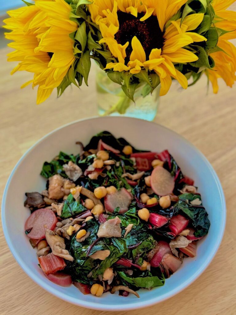 swiss chard and chickpeas in white bowl, with mixed mushrooms