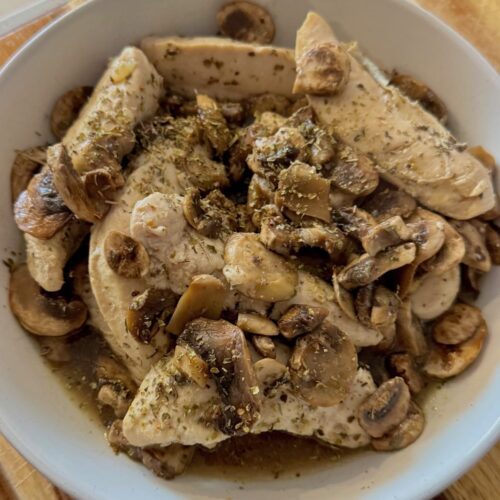 organic chicken, mushrooms, seasoning in white bowl